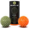 IGELBALL SET Verpackung mit zwei Igelbällen, einem grünen und einem orangefarbenen, Durchmesser 7,5 cm.